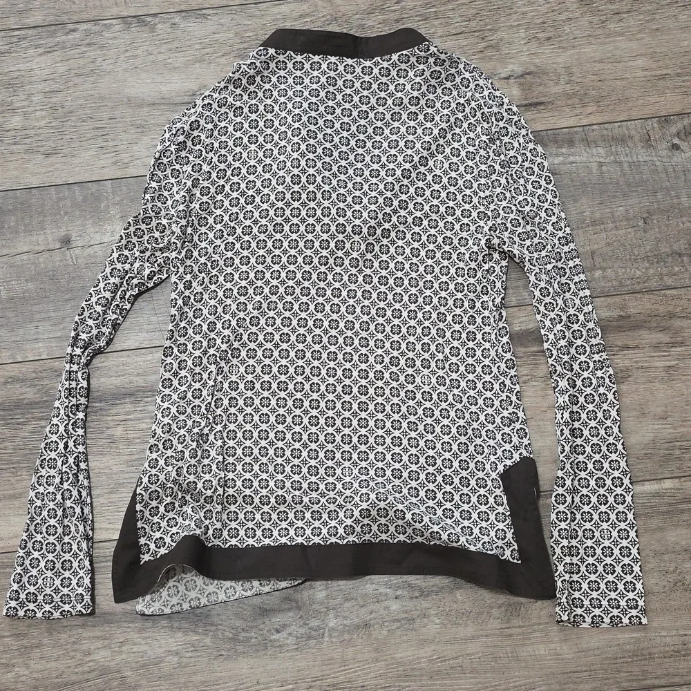 Tory Burch printed tunic top featuring a split neckline and long sleeves